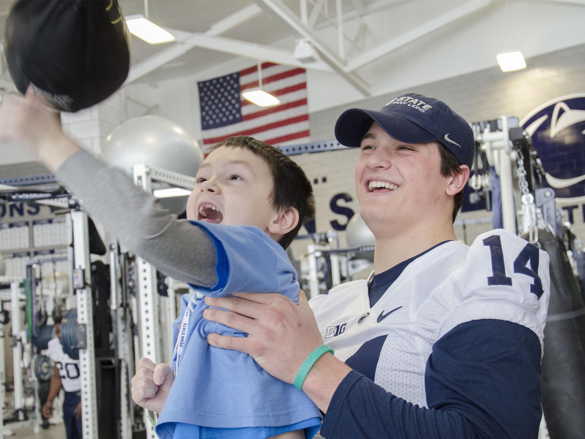 Christian Hackenberg holds a THON child 