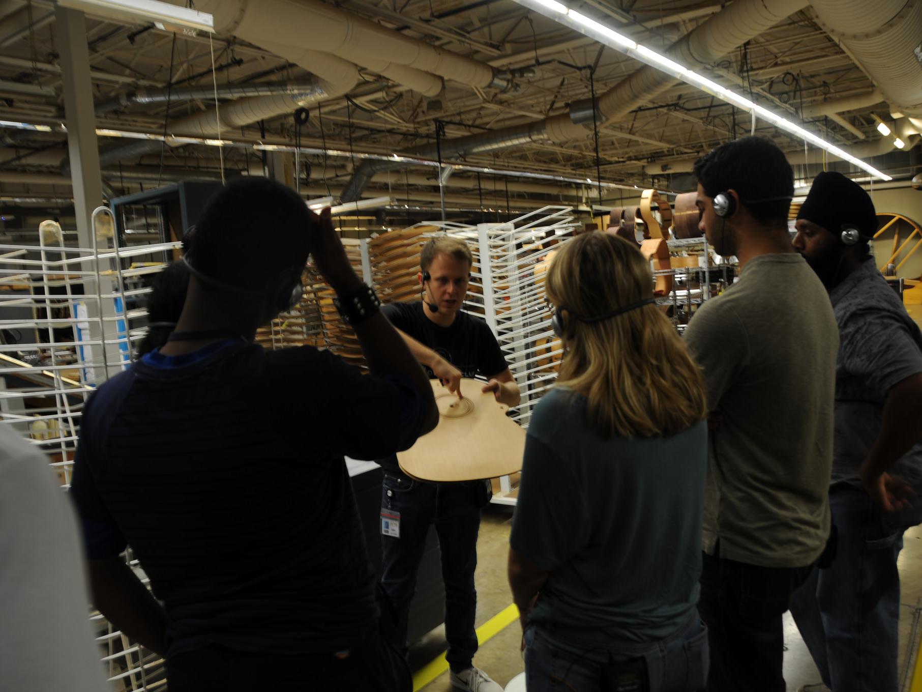 Students touring a guitar factory