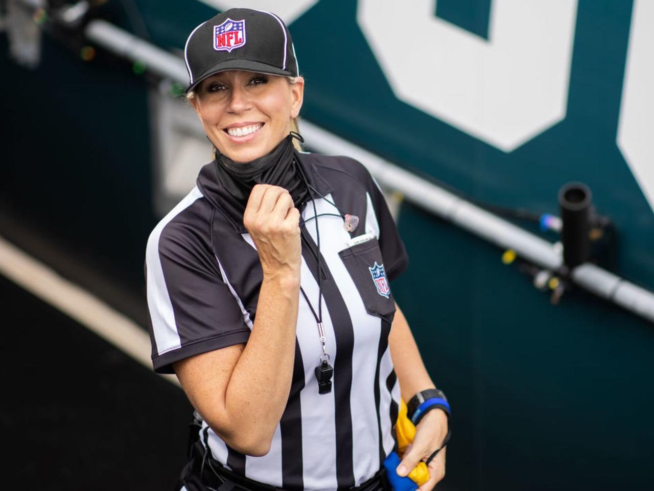 NFL official Sarah Thomas smiles while on the field for a football game.