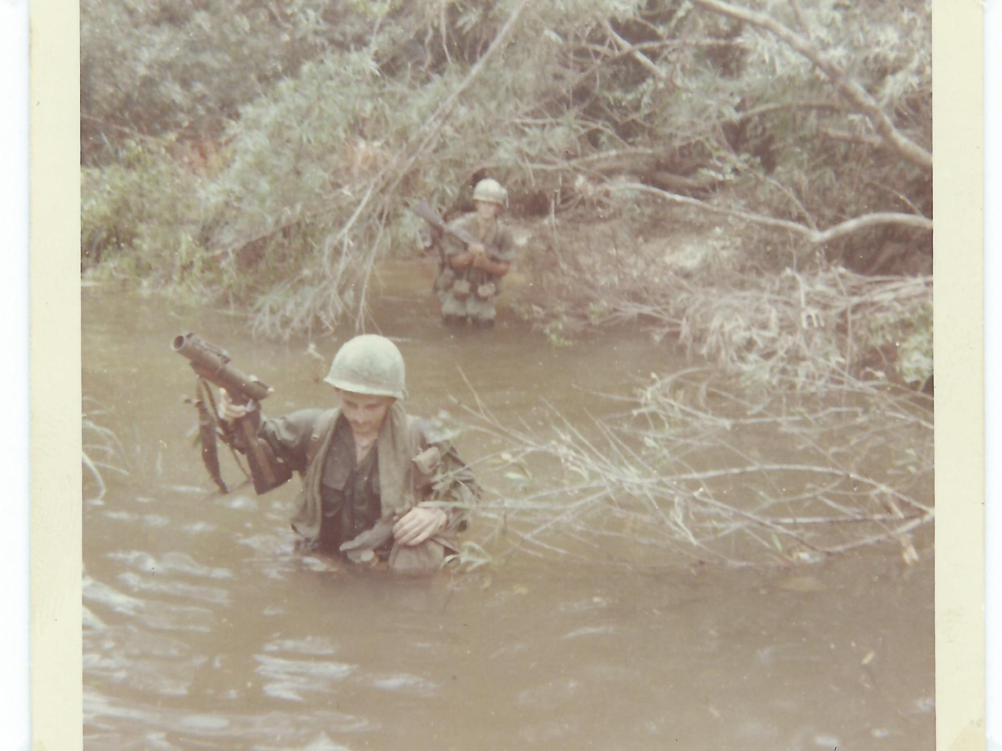 Tom Roney crossing a river