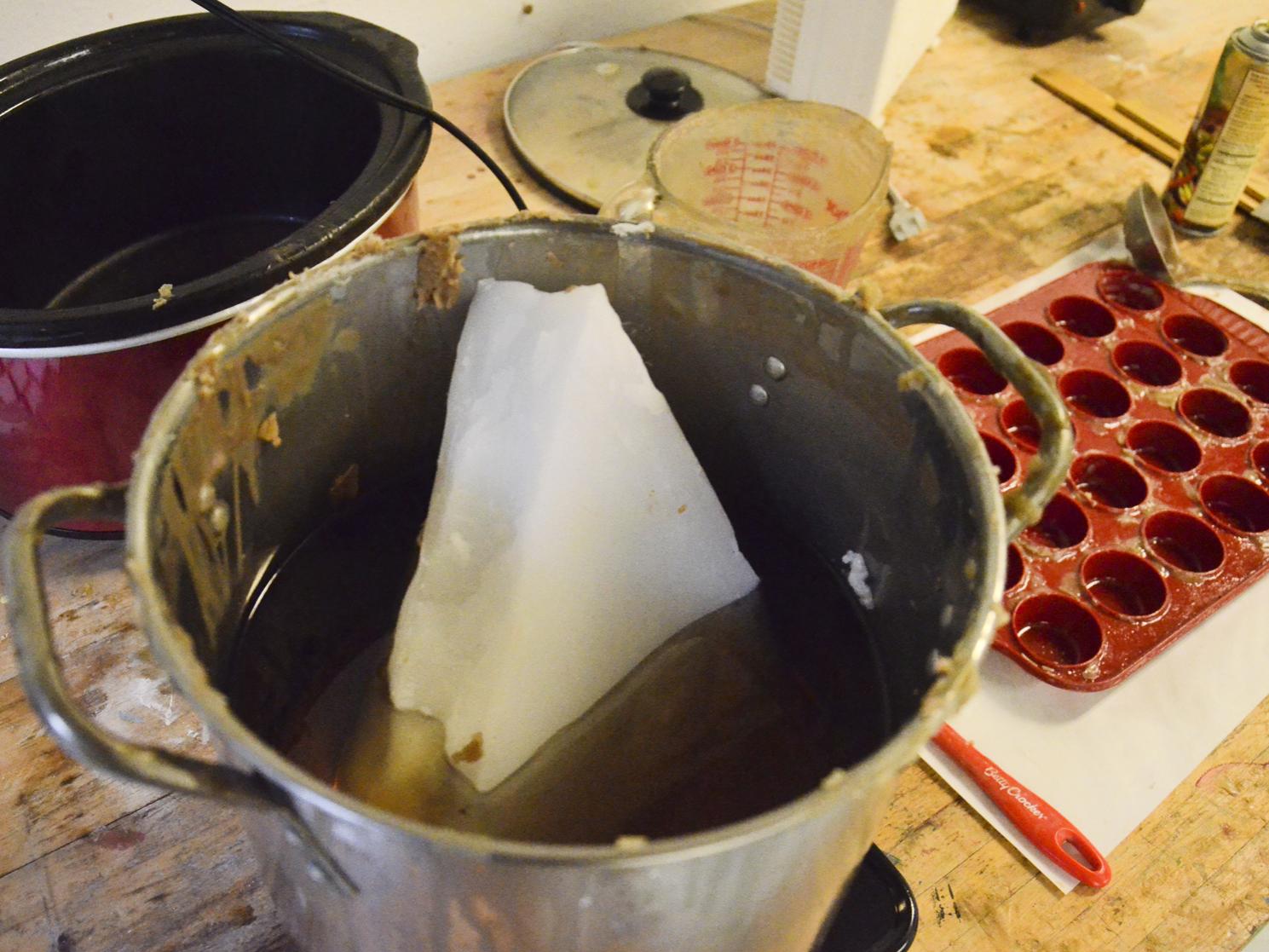 The pot and cookie pan used to make wax dollops