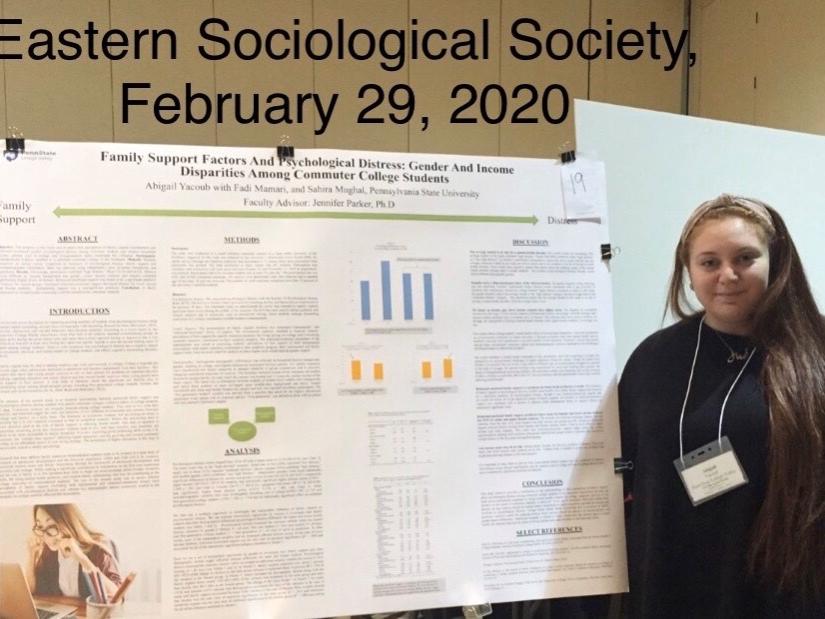 female student with her research poster