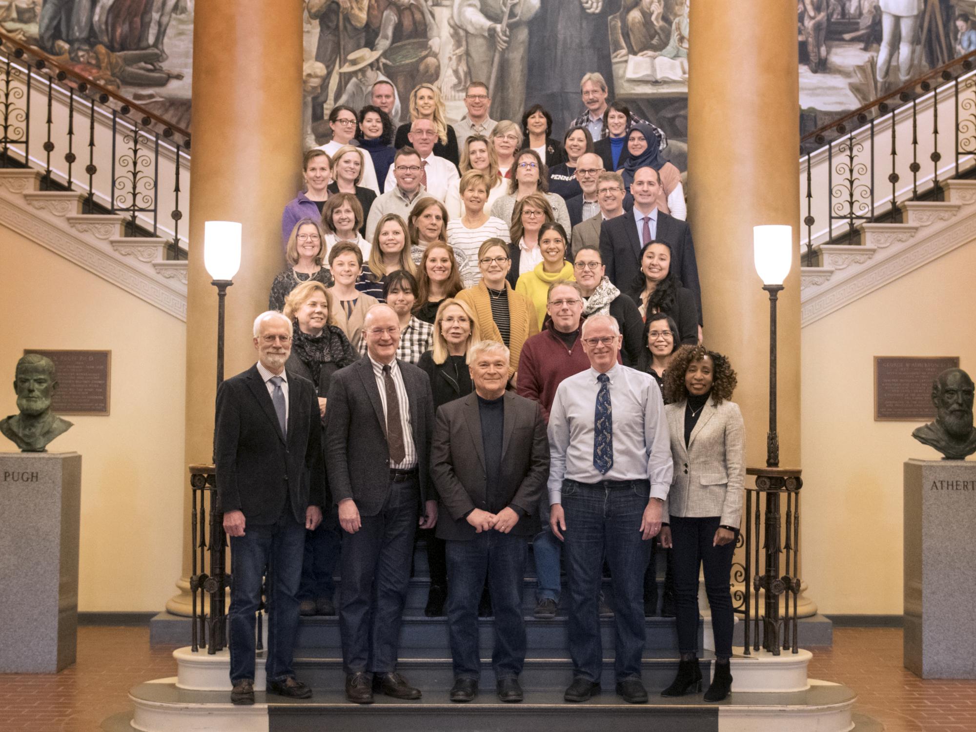 Old Main staff on steps wearing blue jeans