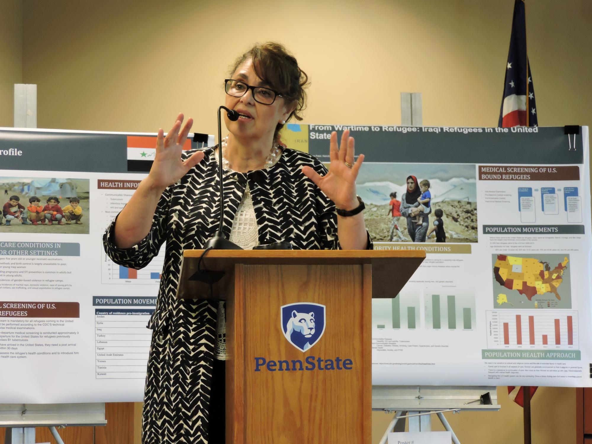 Verónica Montecinos speaking at a podium
