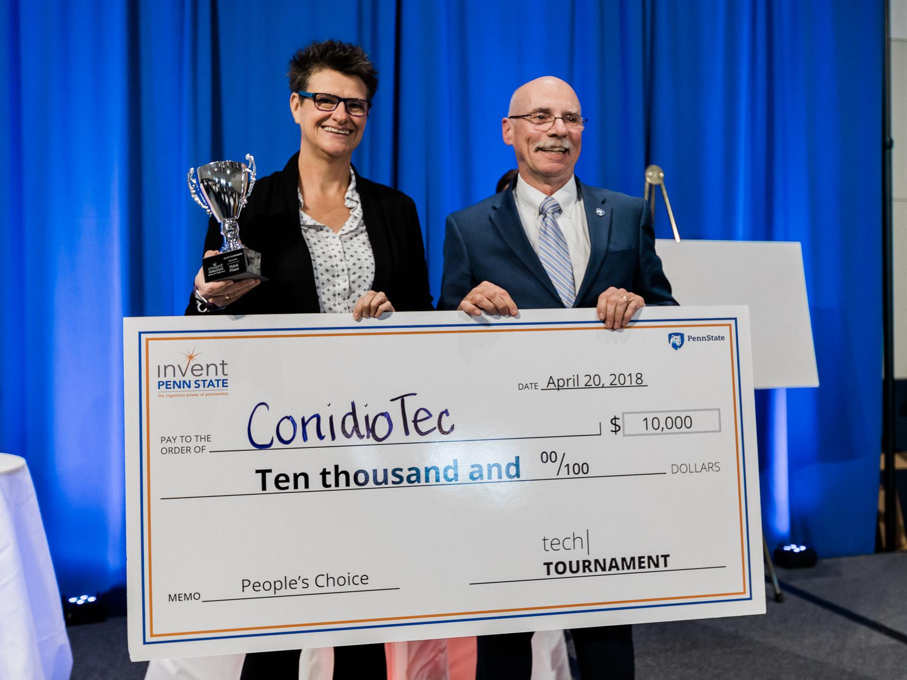 ConidioTec Founder and CTO Nina Jenkins accepts a check for $10,000 as the People's Choice Award Winner at the 2018 Tech Tournament during the Invent Penn State Venture & IP Conference.