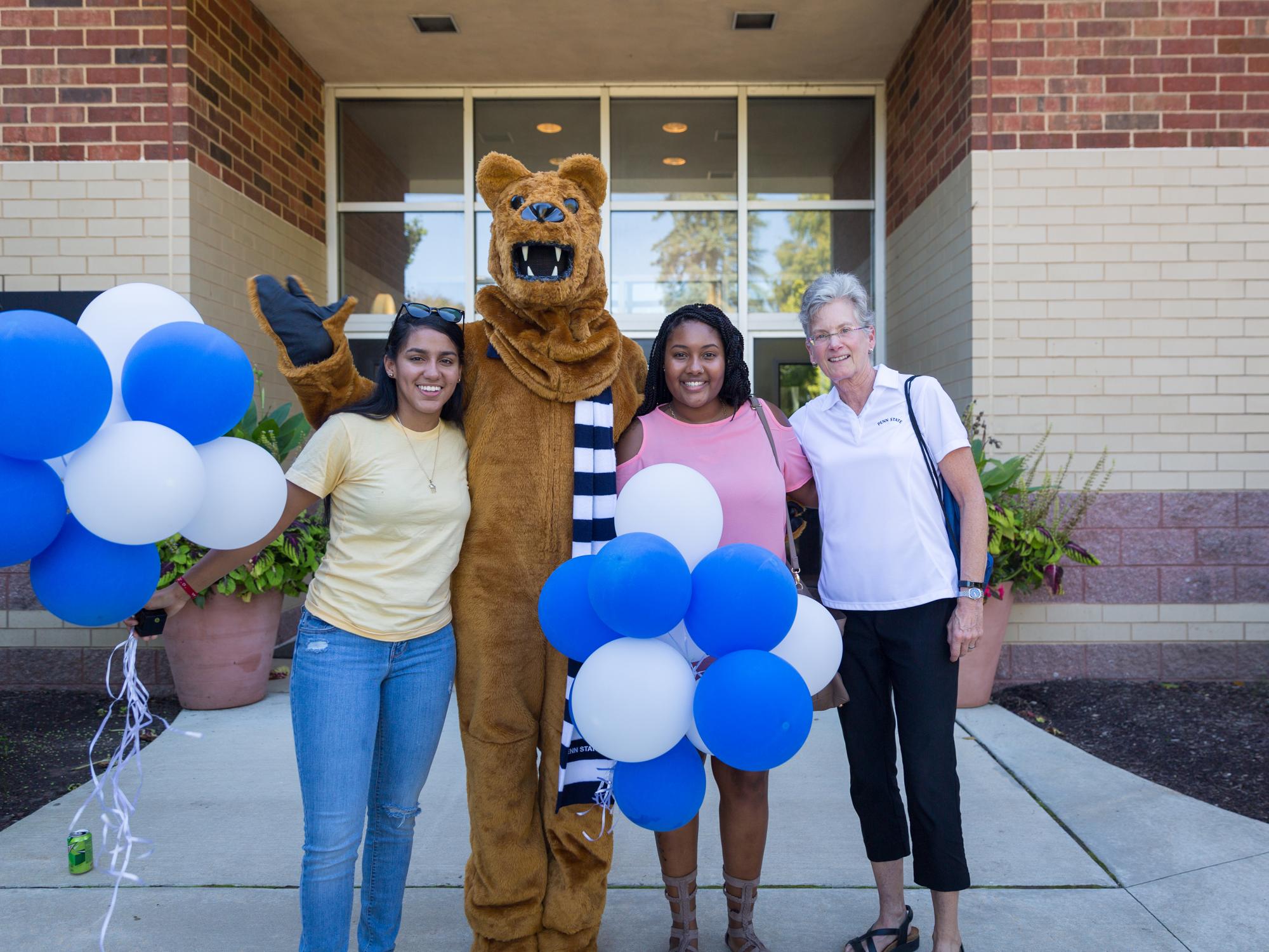 Chancellor Kristin Woolever congratulates Myeisha Matos and Donna Aggie