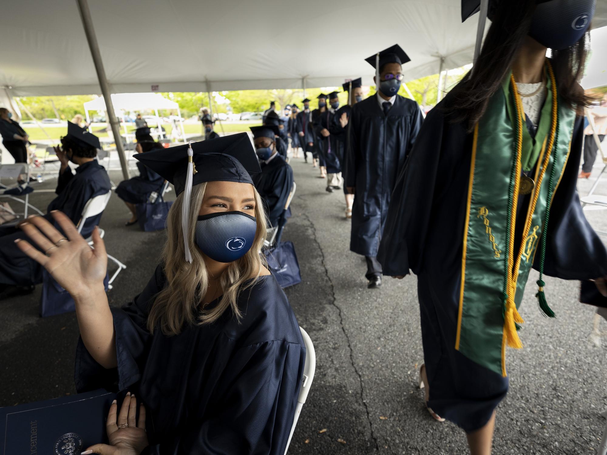 masked graduates walked into tent