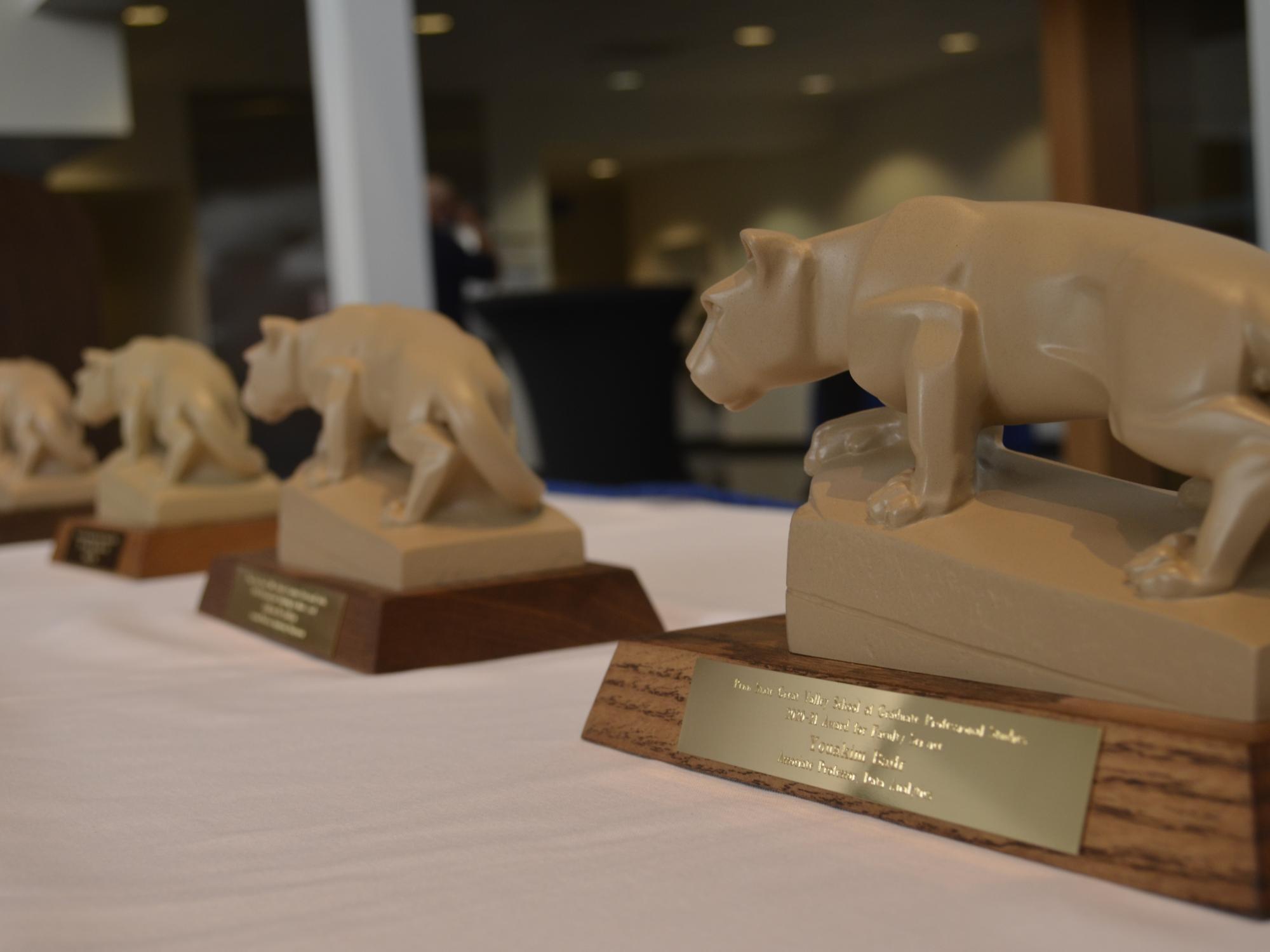 Four small lion states on a table