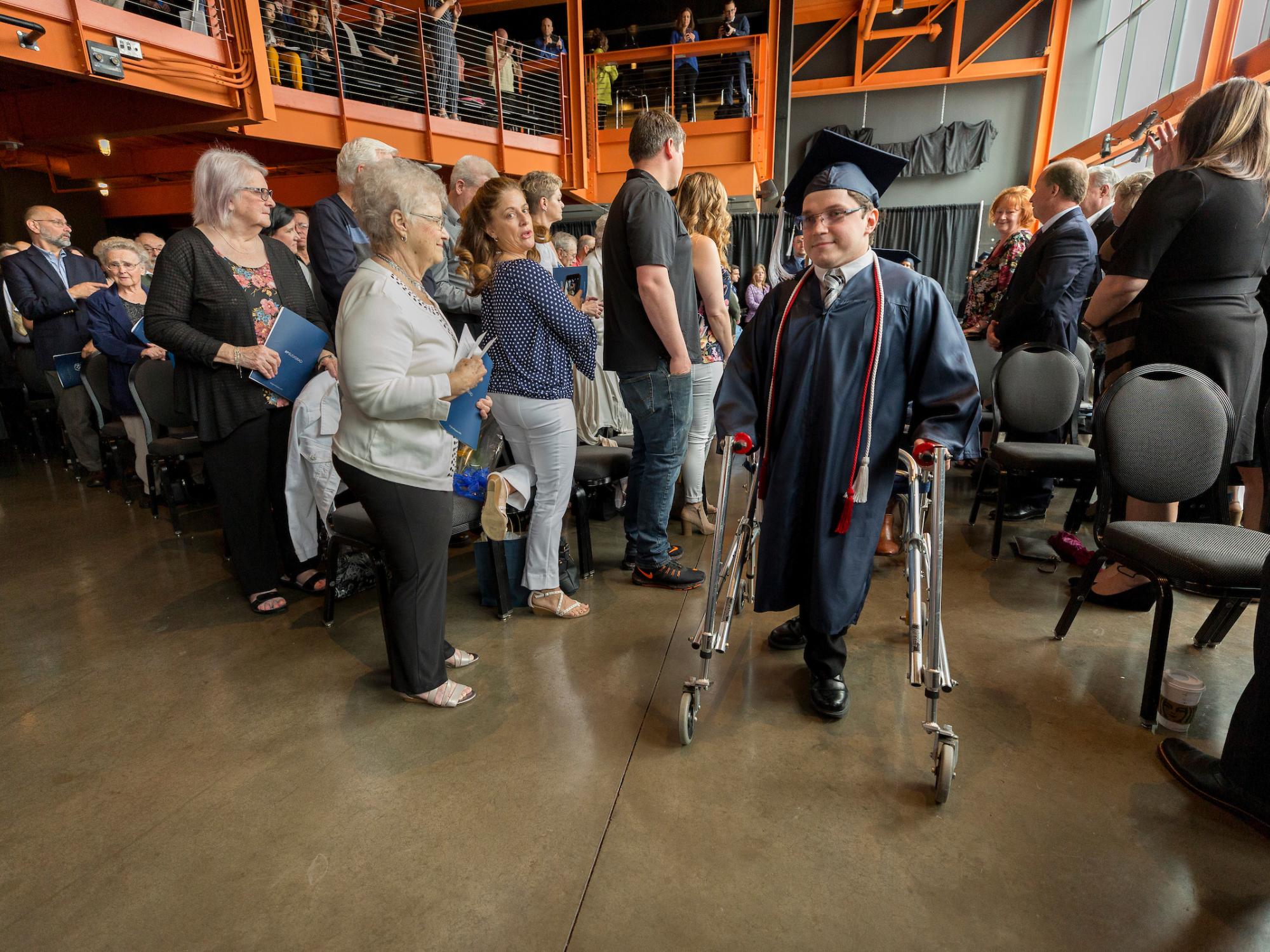 man processing in using a walker