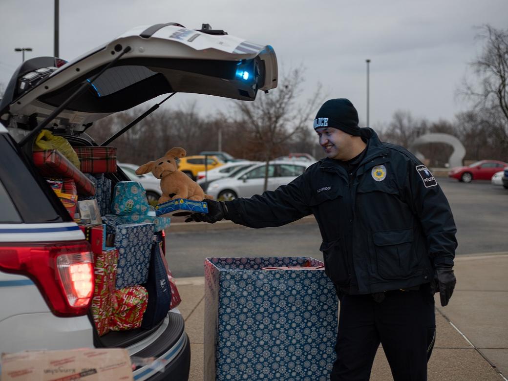 Police officer places gift in car