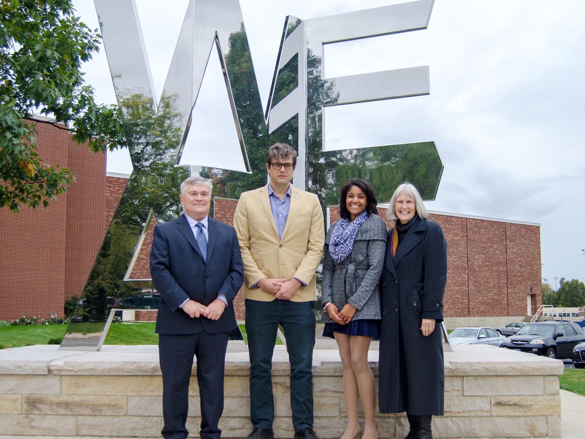 Group of people posing in front of the We Are Sculpture