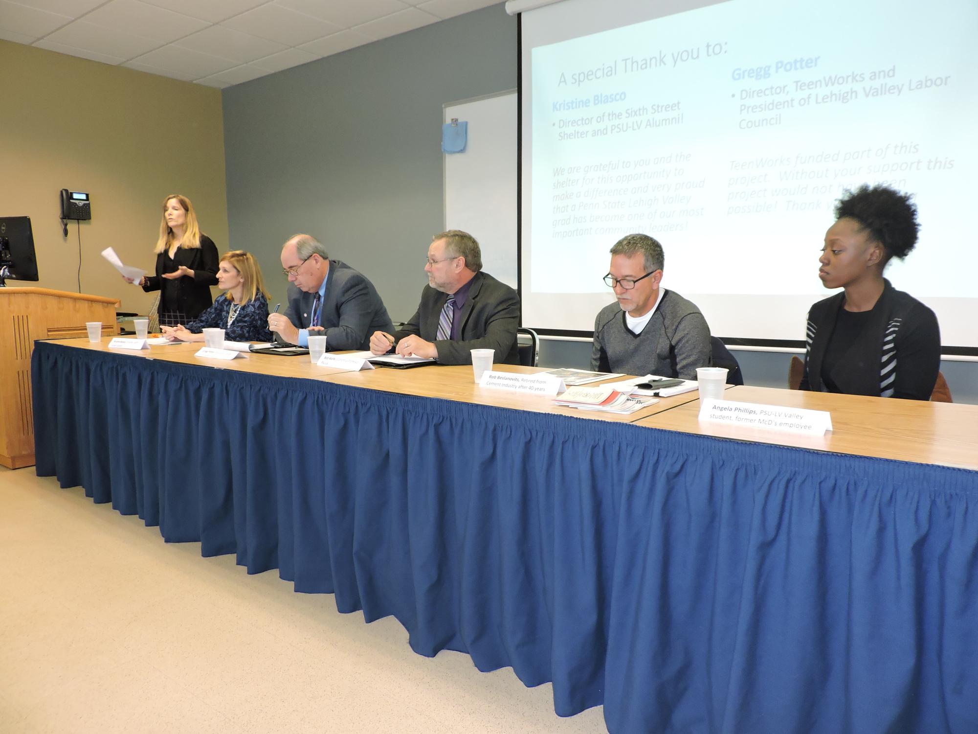 line of panelists speaking at event