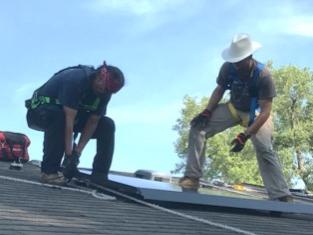 Men install solar PV array
