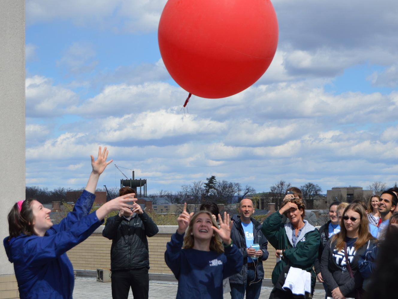 students releasing weather balloon