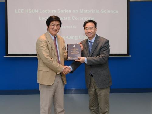 man receiving plaque on stage