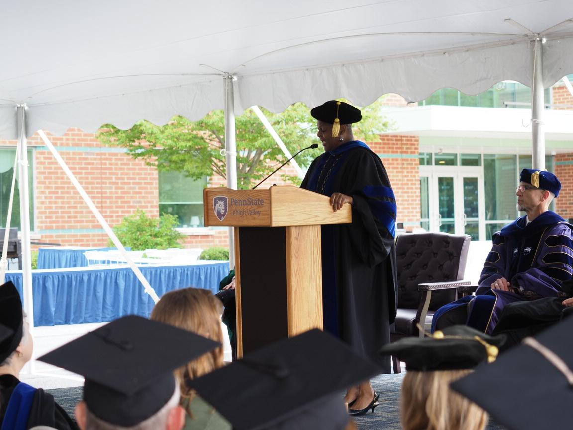 woman in academic dress at podium