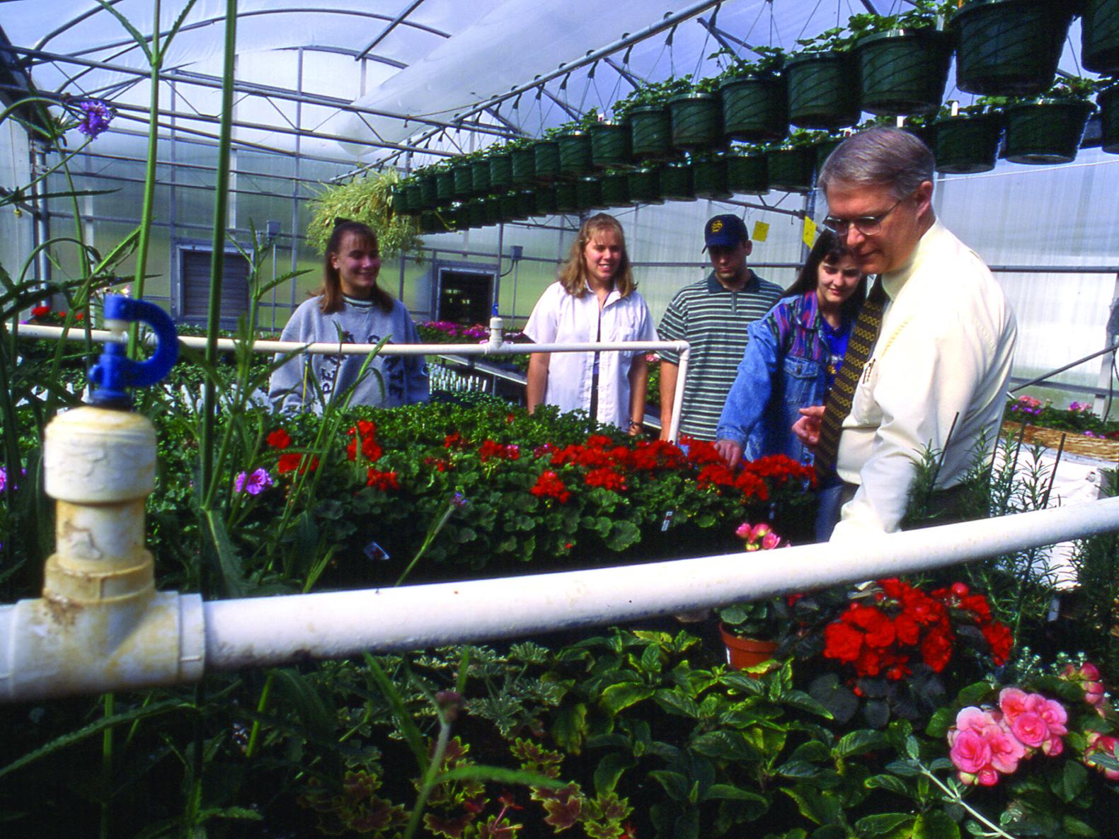 Dr. Sanford and student in greenhouse