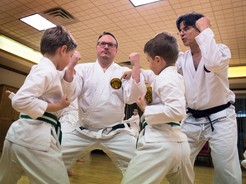 Father and sons in karate class