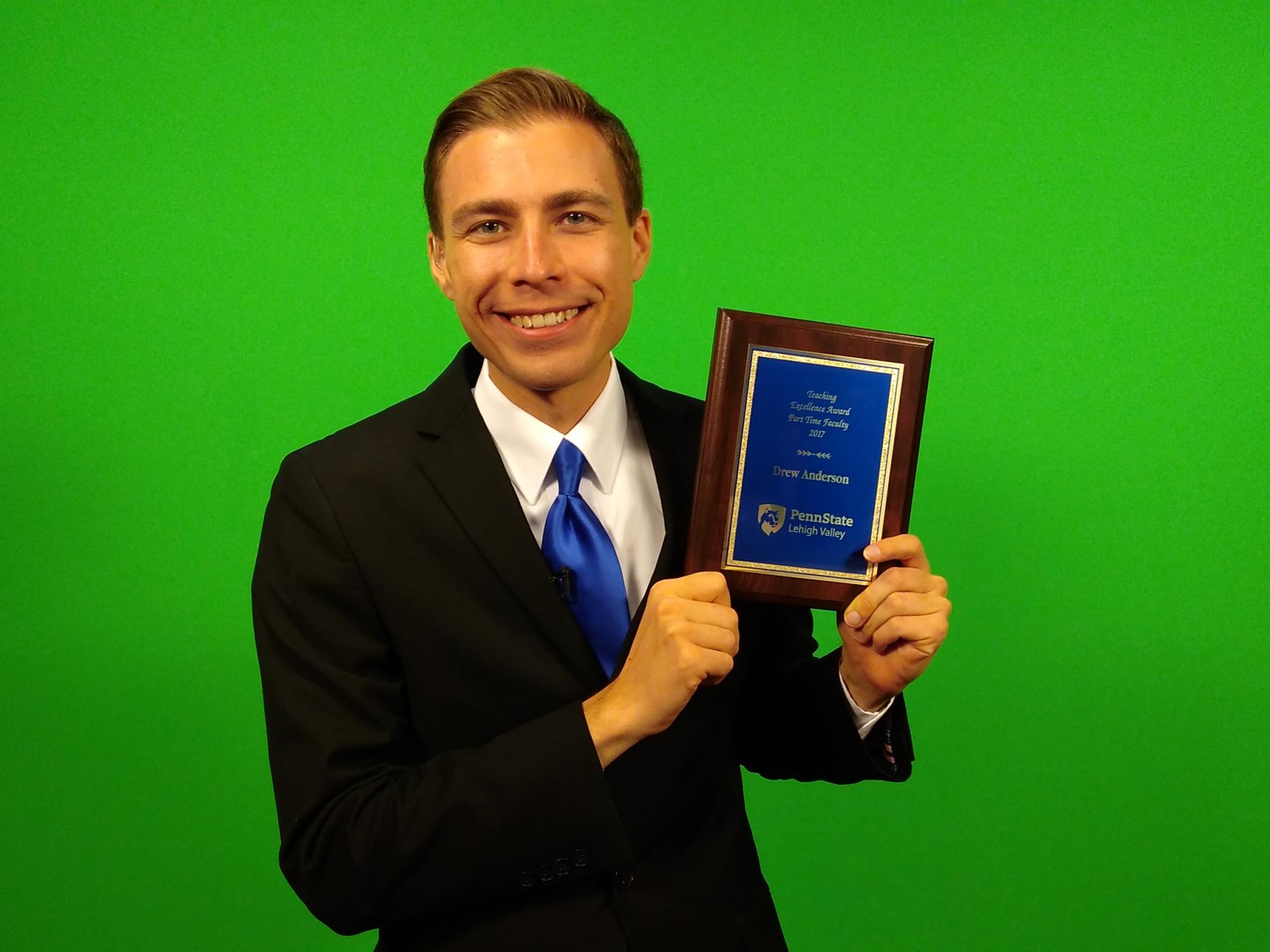 man holding award
