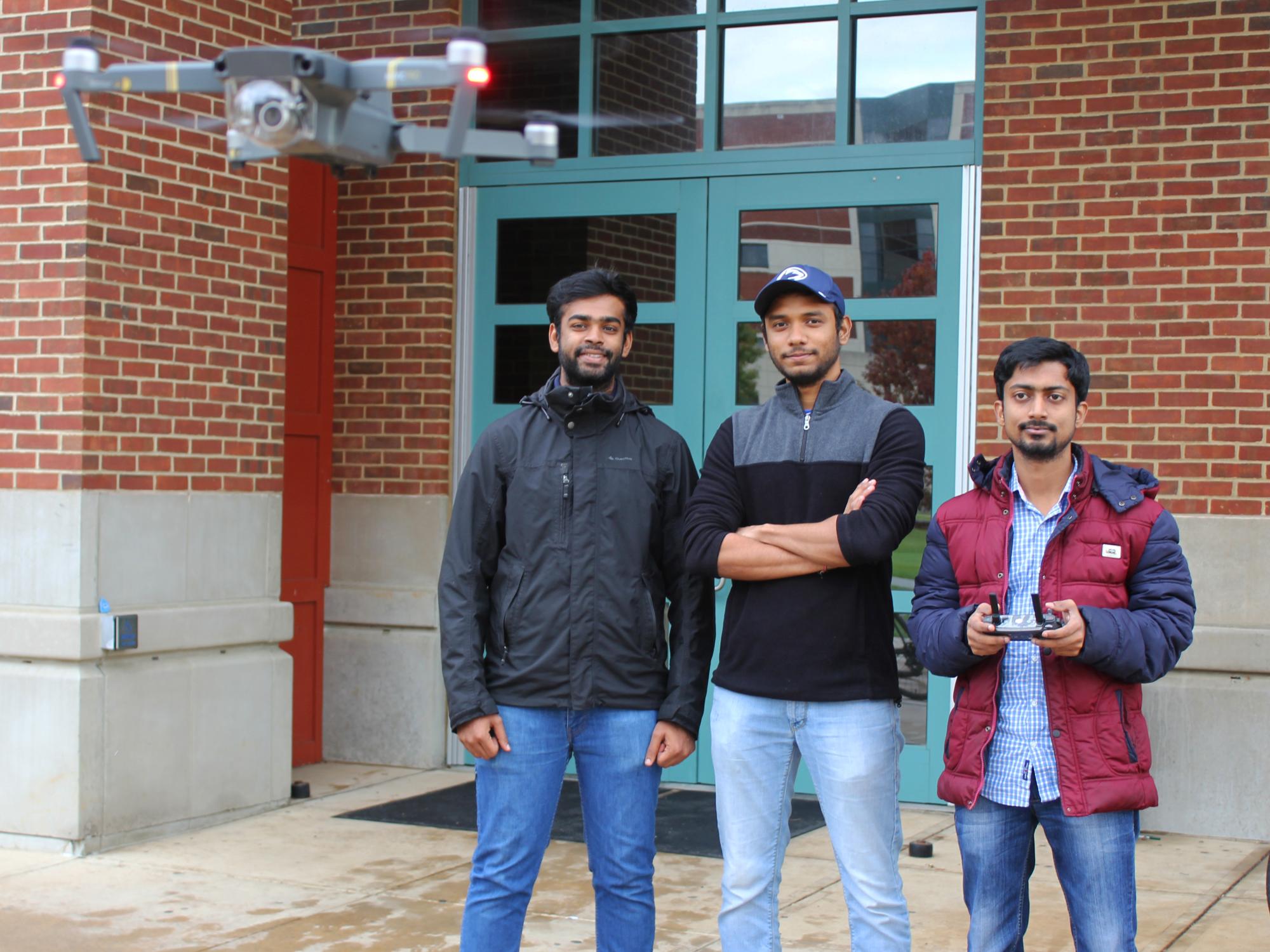 Members of the SEAL team standing in front of Leonhard building with drone