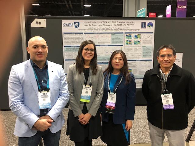 four people in front of a poster board