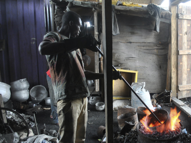 man forges object from sheet metal