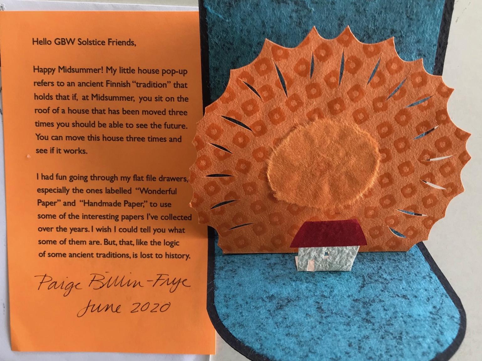 typed explanation sheet at left, 3D pop-up card with small house in front of large bright sun