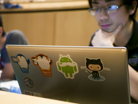 Stanley Chan works at a laptop during HackPSU