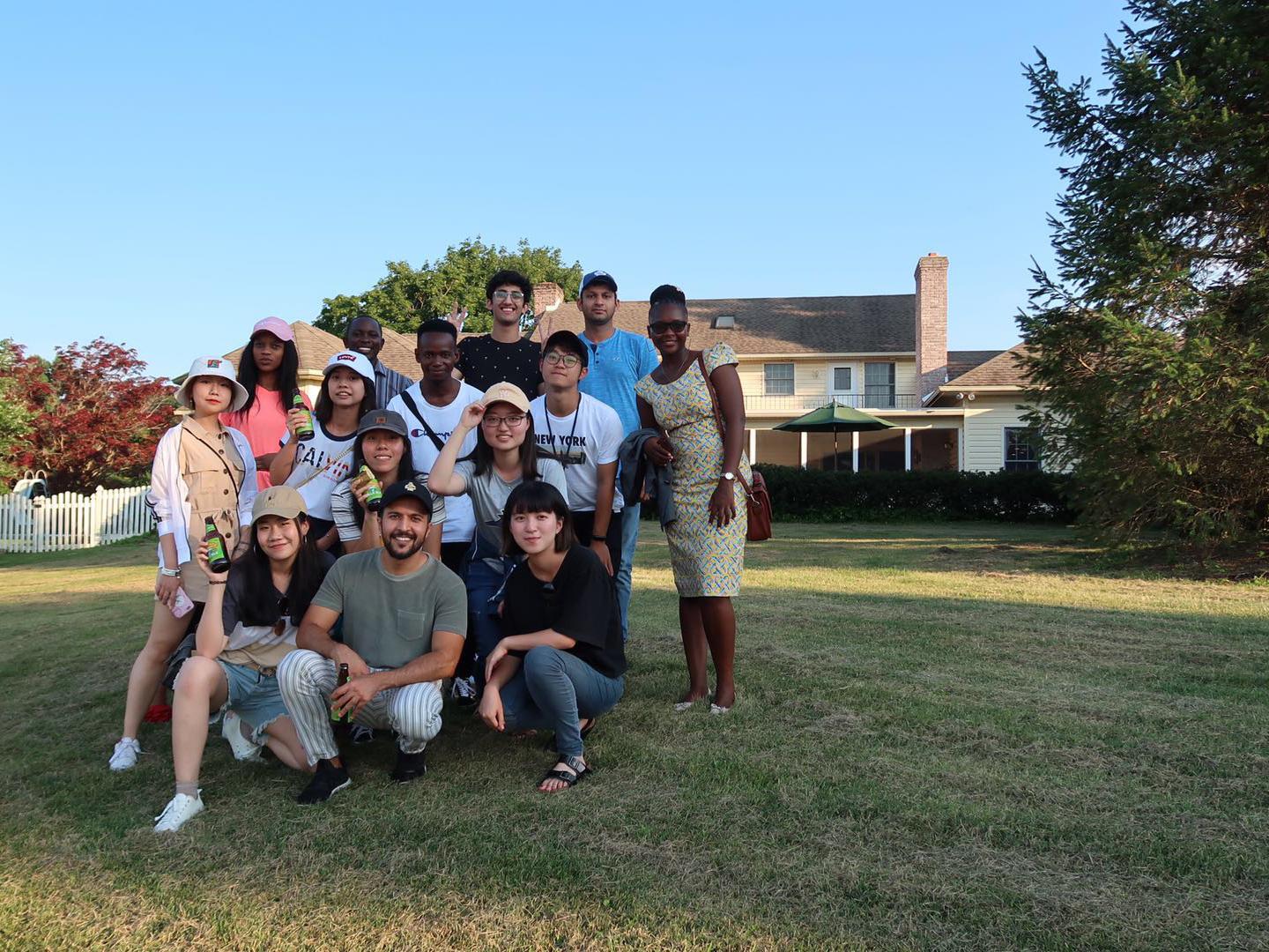 International students participating in the Global Health Exchange Program standing outside a house.