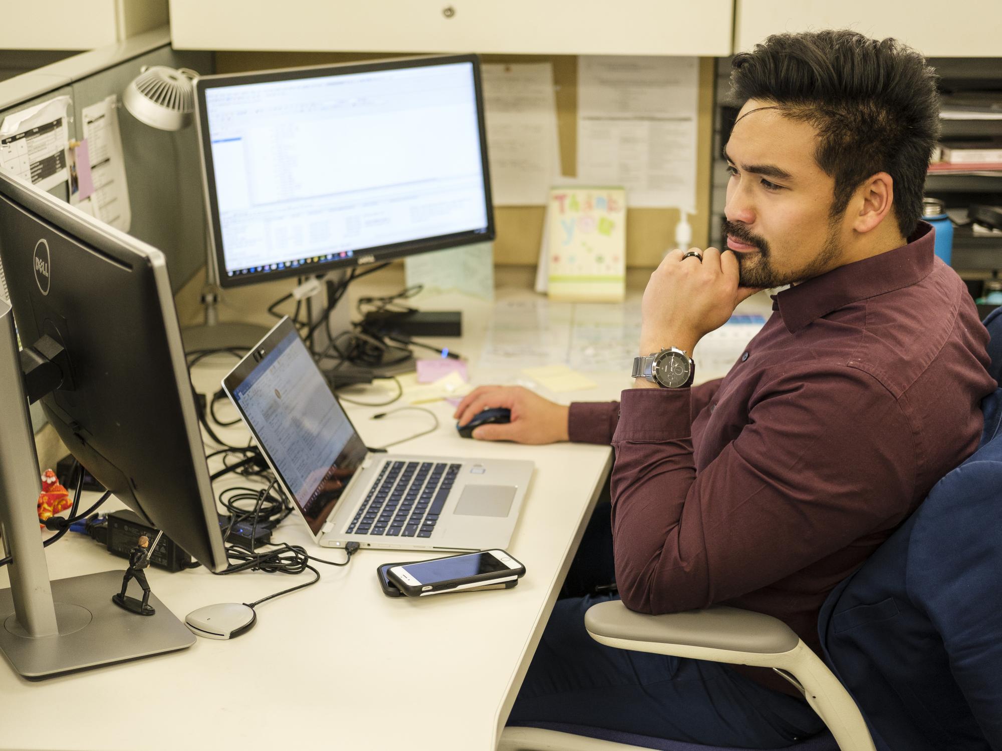 man looking at computer monitor