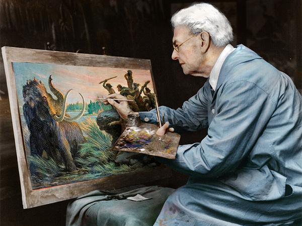 Charles R. Knight posing at one of his paintings.
