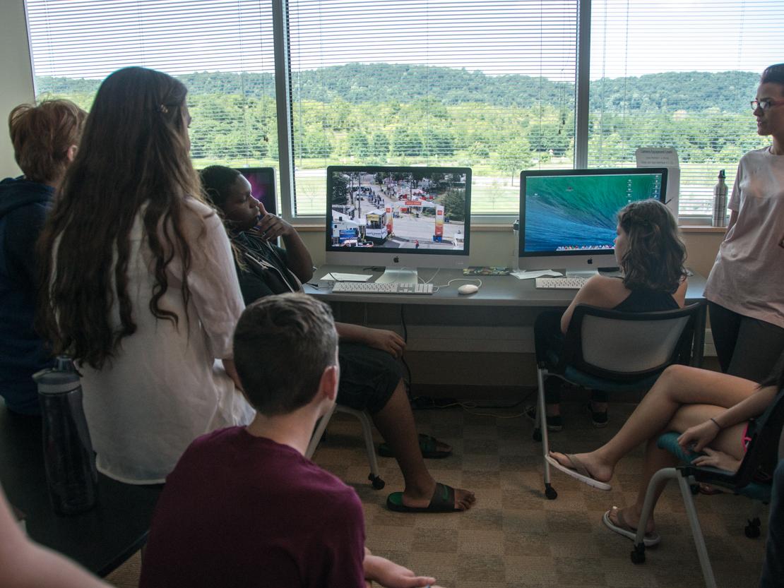 A group of campers view their final video projects.