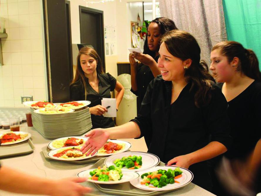 students serving dinner