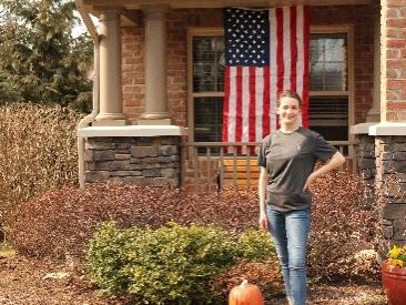 Man stands in front of house