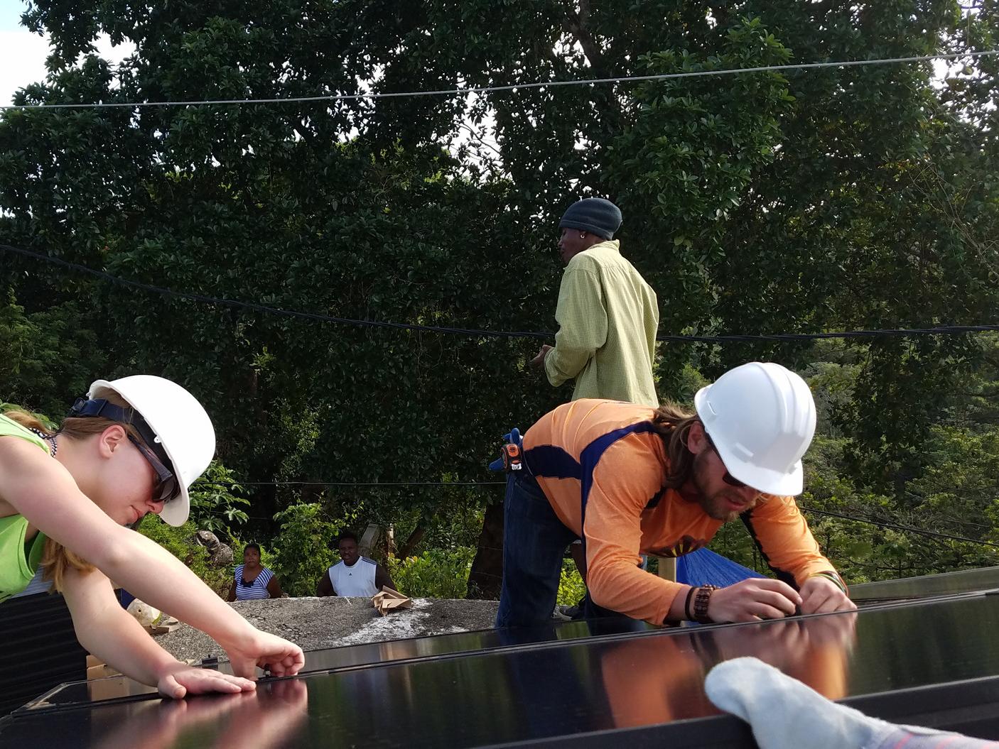 students installing solar panels