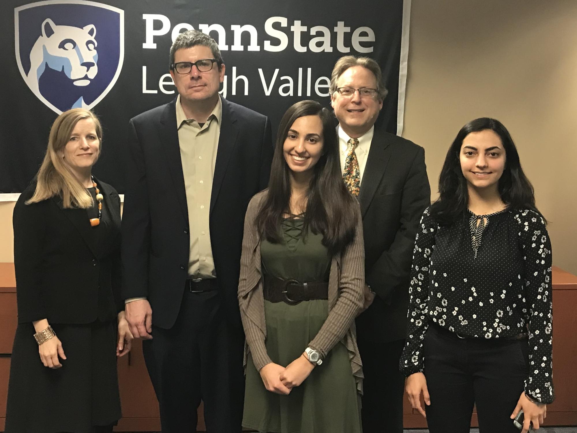 five people in front of PSU-LV banner