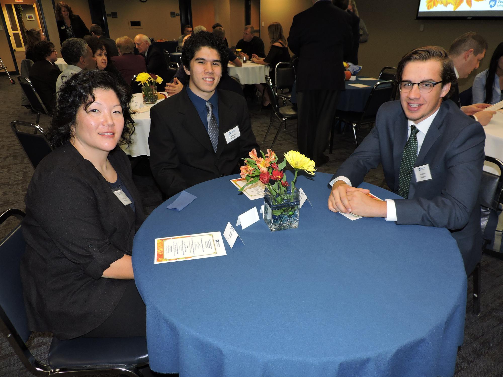 A mom, her son and another student at a dinner table