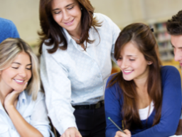 group of professionals leaning over desk