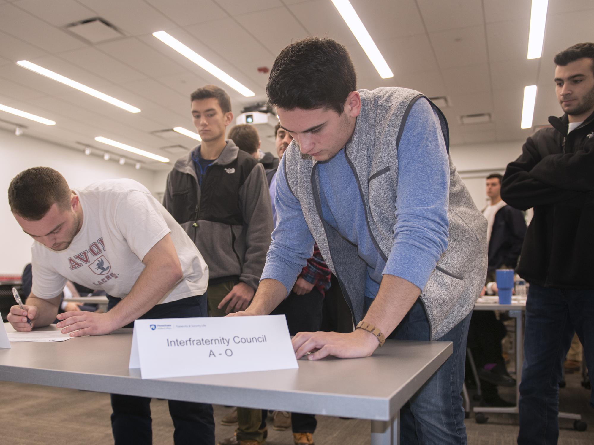 Greek-letter organization student leaders gather to sign the relationship statement on Dec. 5.