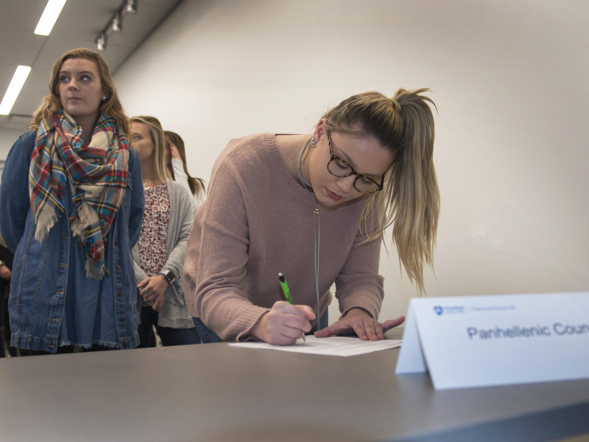 Greek-letter organization student leaders gather to sign the relationship statement on Dec. 5.