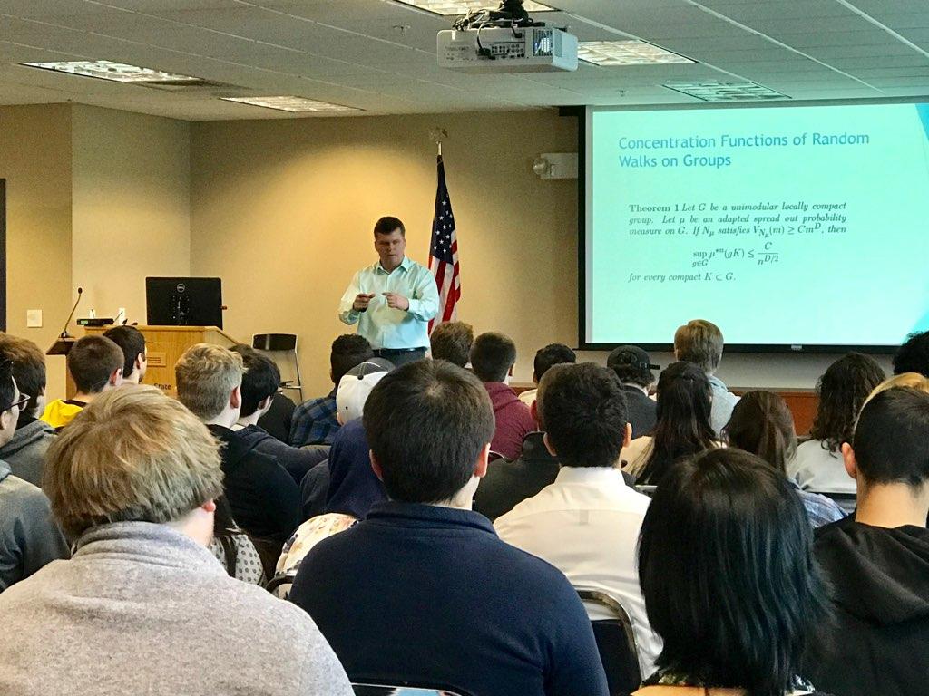 Man presenting to students in front of a screen