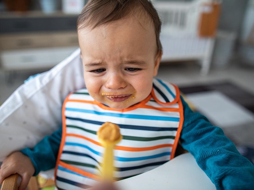 crying boy eating
