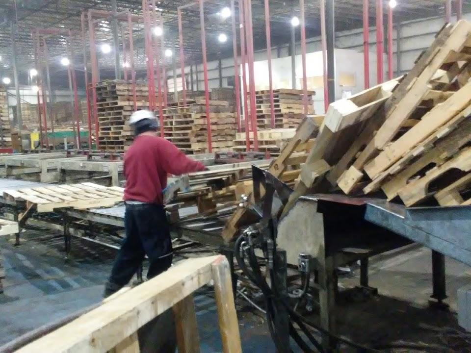 worker fixing pallets
