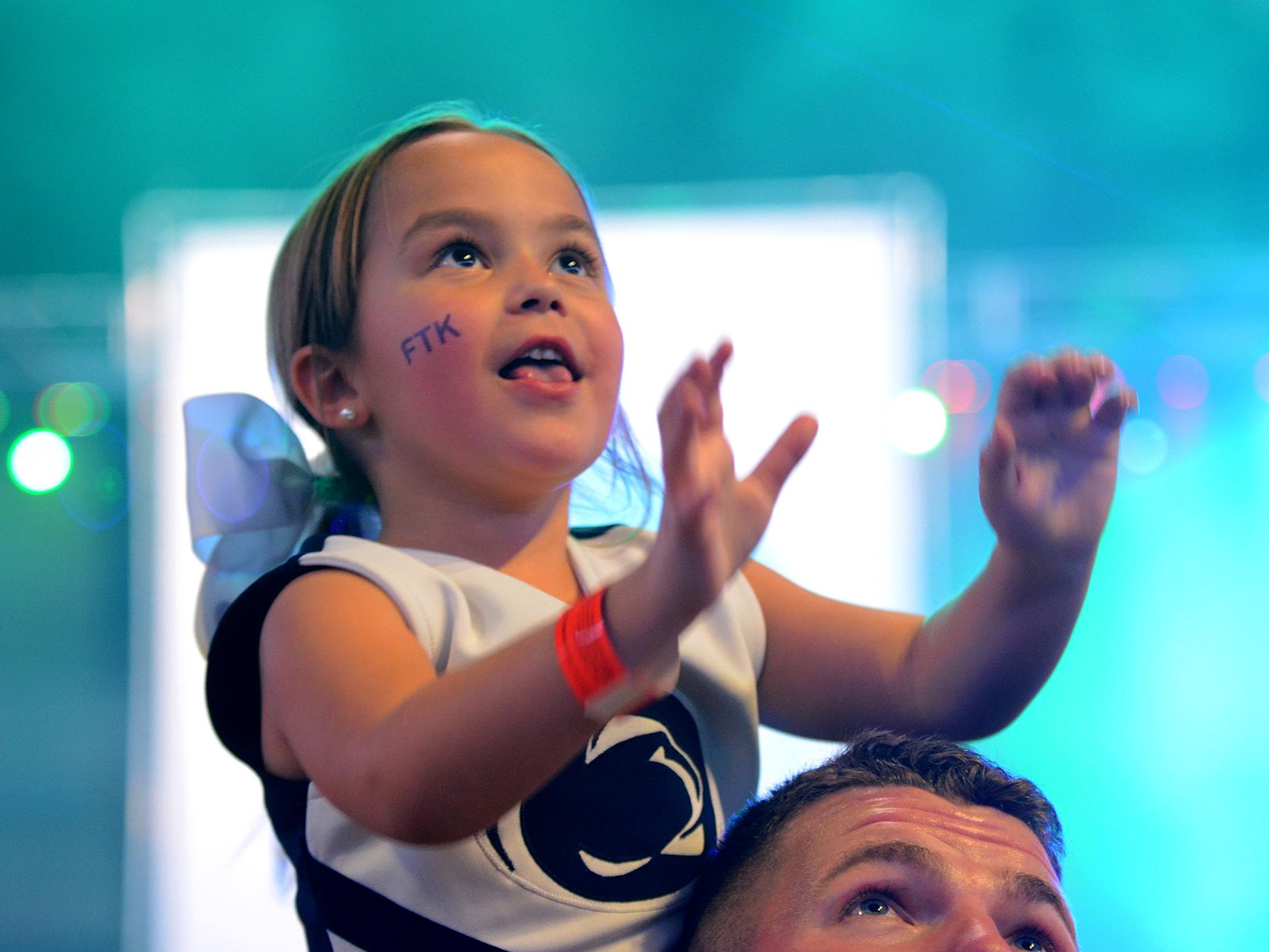 THON child on the shoulders of a student