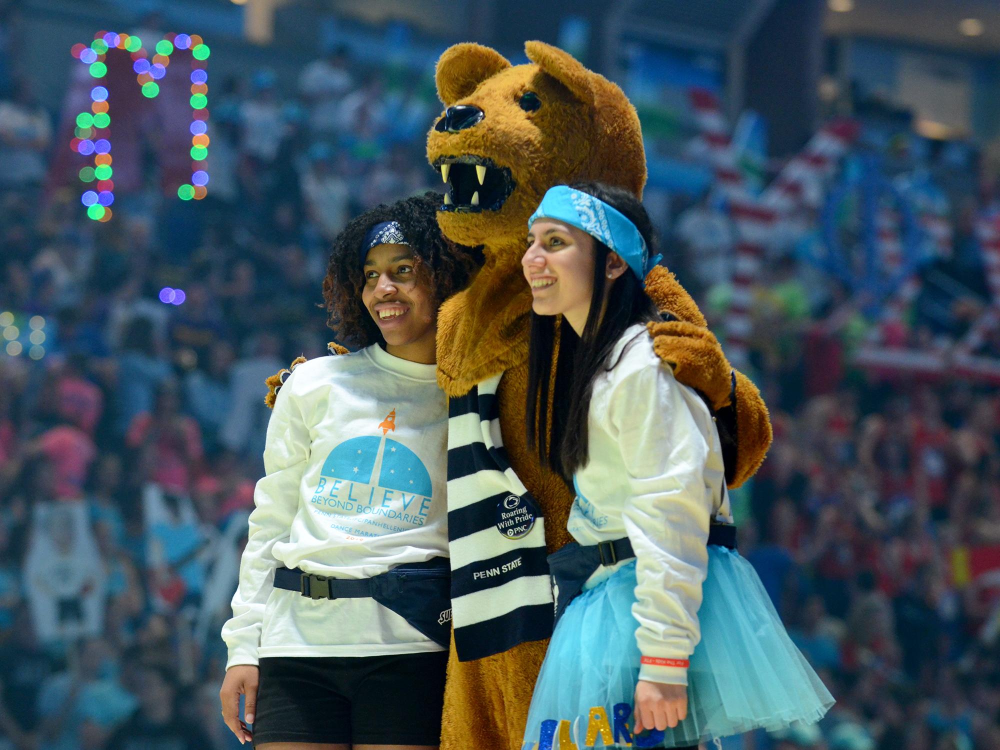 Two students pose for a photo with the Nittany Lion at THON 2016.