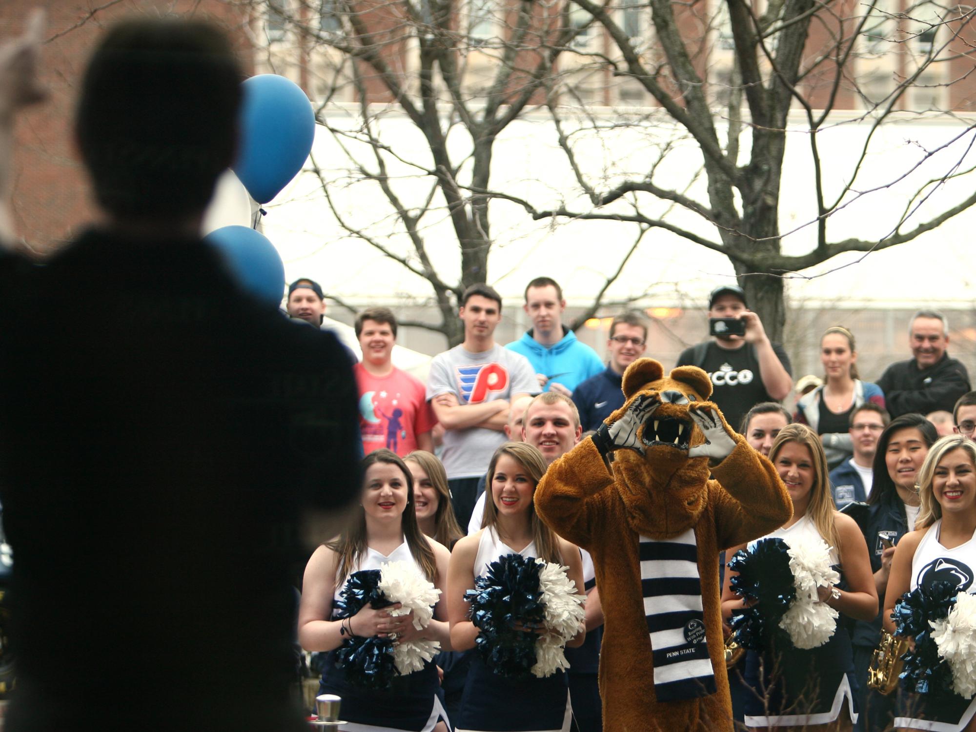 Jeff Gordon leads a cheer at the Creamery as Penn State cheerleaders and the Nittany Lion look on.