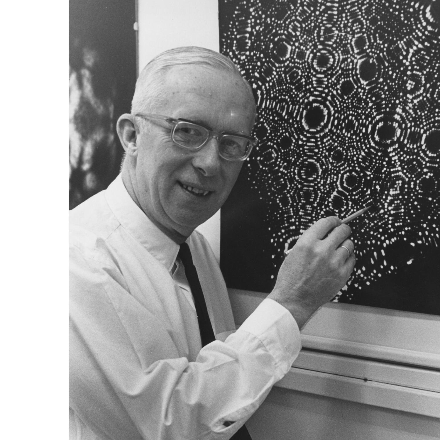 researcher showing an image taken with a microscope