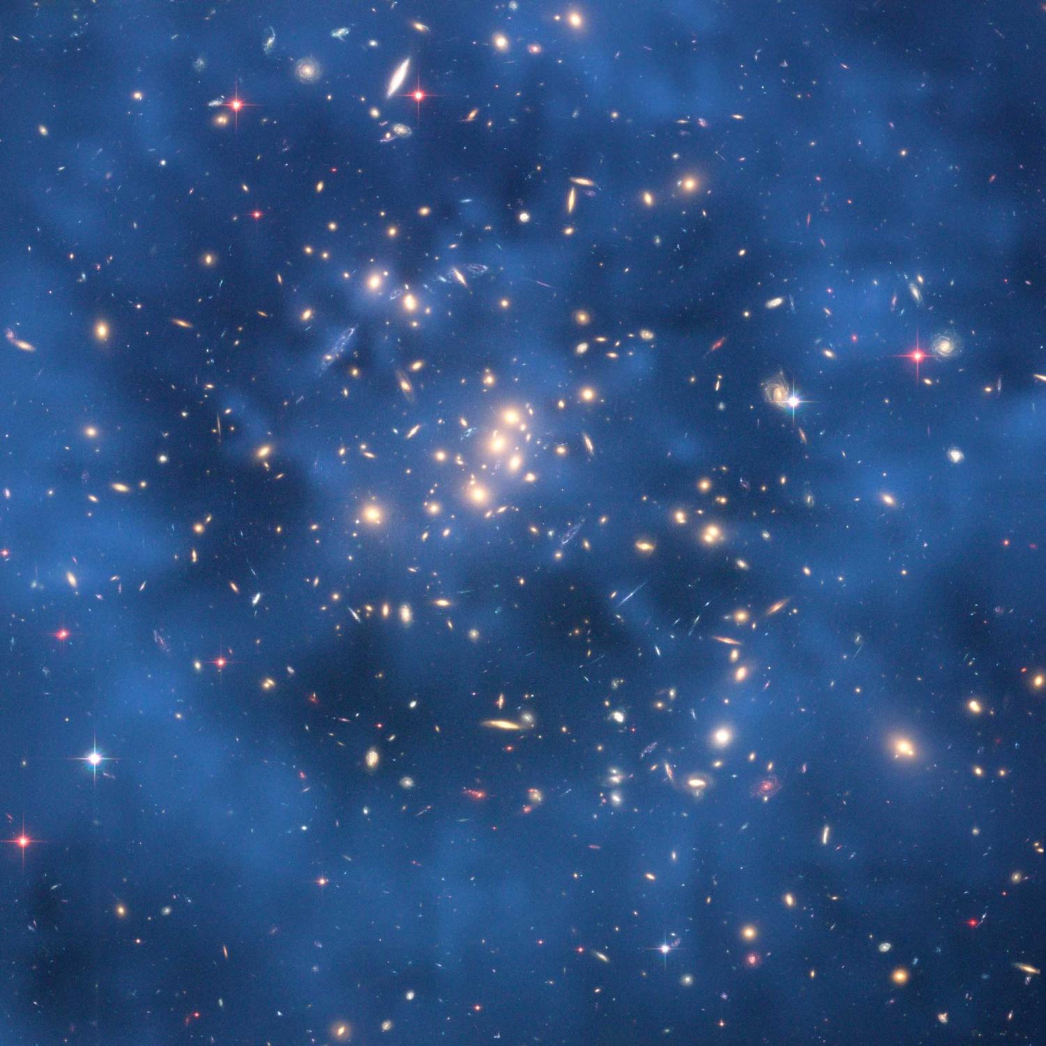 galaxy cluster with blue haze in rings around central stars