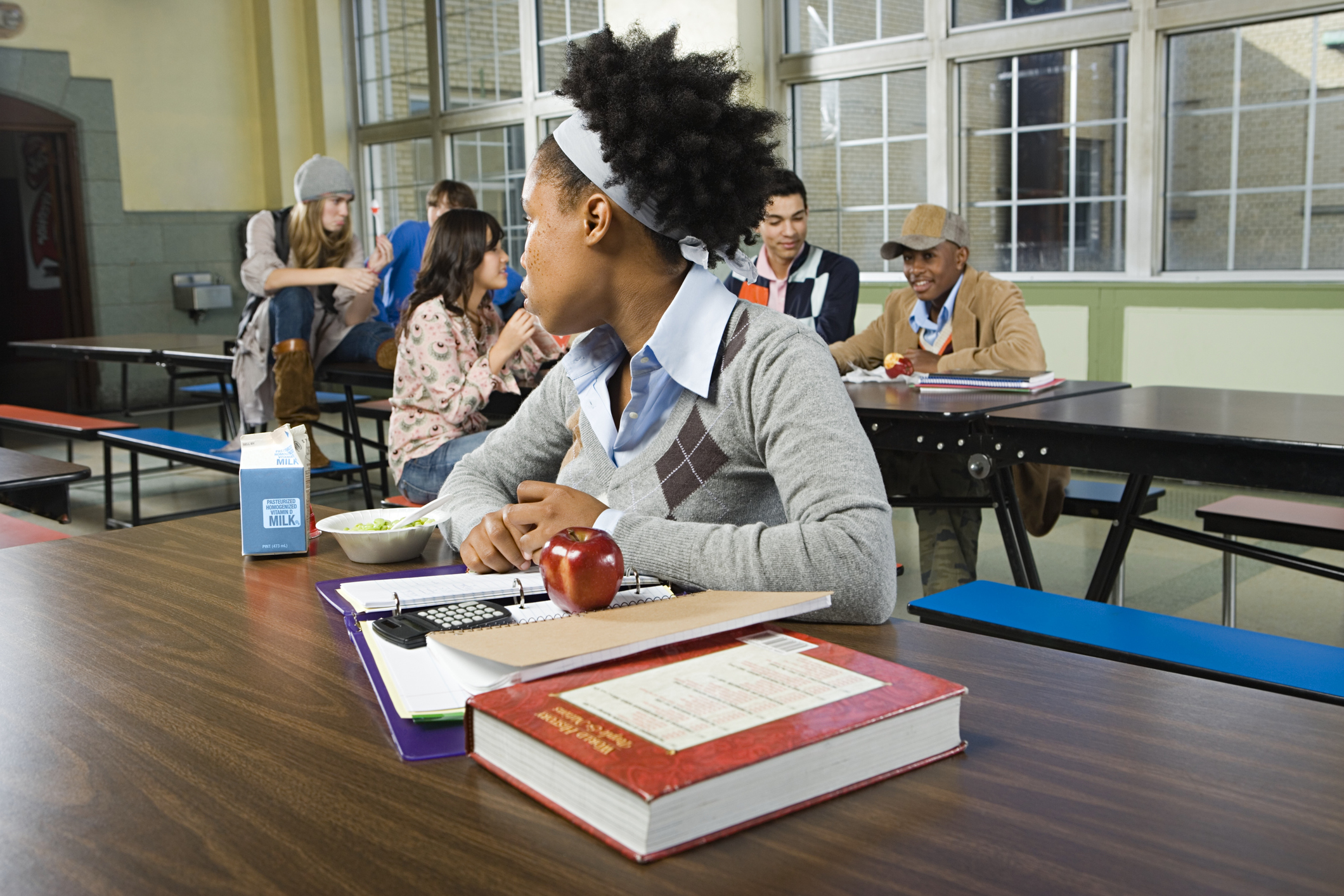 girl alone at lunch table