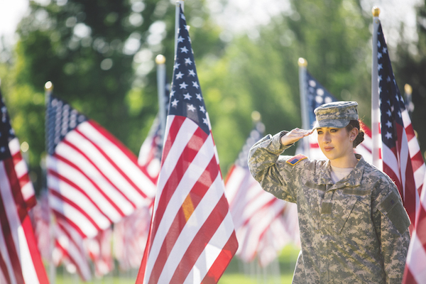 Female Army veteran and flags